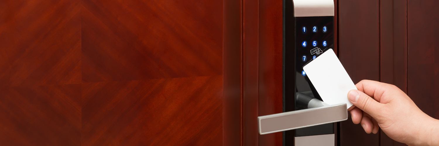 Key card being held up to an electronic door lock